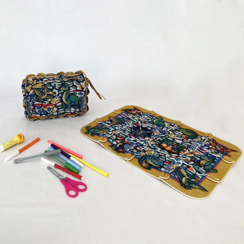 LinkKit dinosaur modular textile placemat with colorful pencils and creative pieces