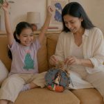 Child and mother building a LinkKit starship large pouch textile kit at home